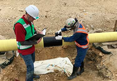 Certified Industrial Hygienist (CIH) inspecting the safety and health of workers during pipeline coating operations in Okinawa, Japan